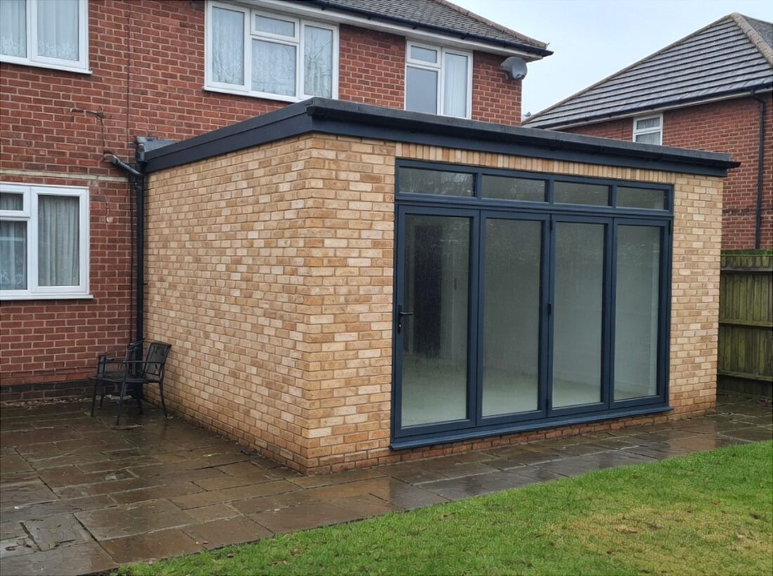 Rear brick extension with grey bifold doors and patio