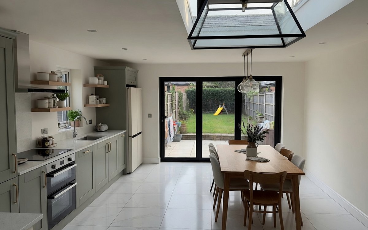 Open-plan kitchen-diner with roof lantern and sliding doors to the garden