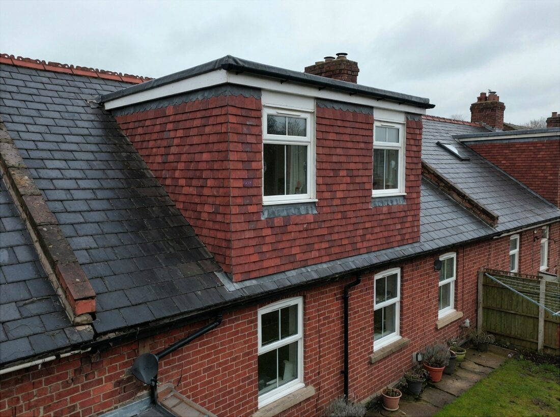 Rear box dormer with hanging tiles on a brick terrace